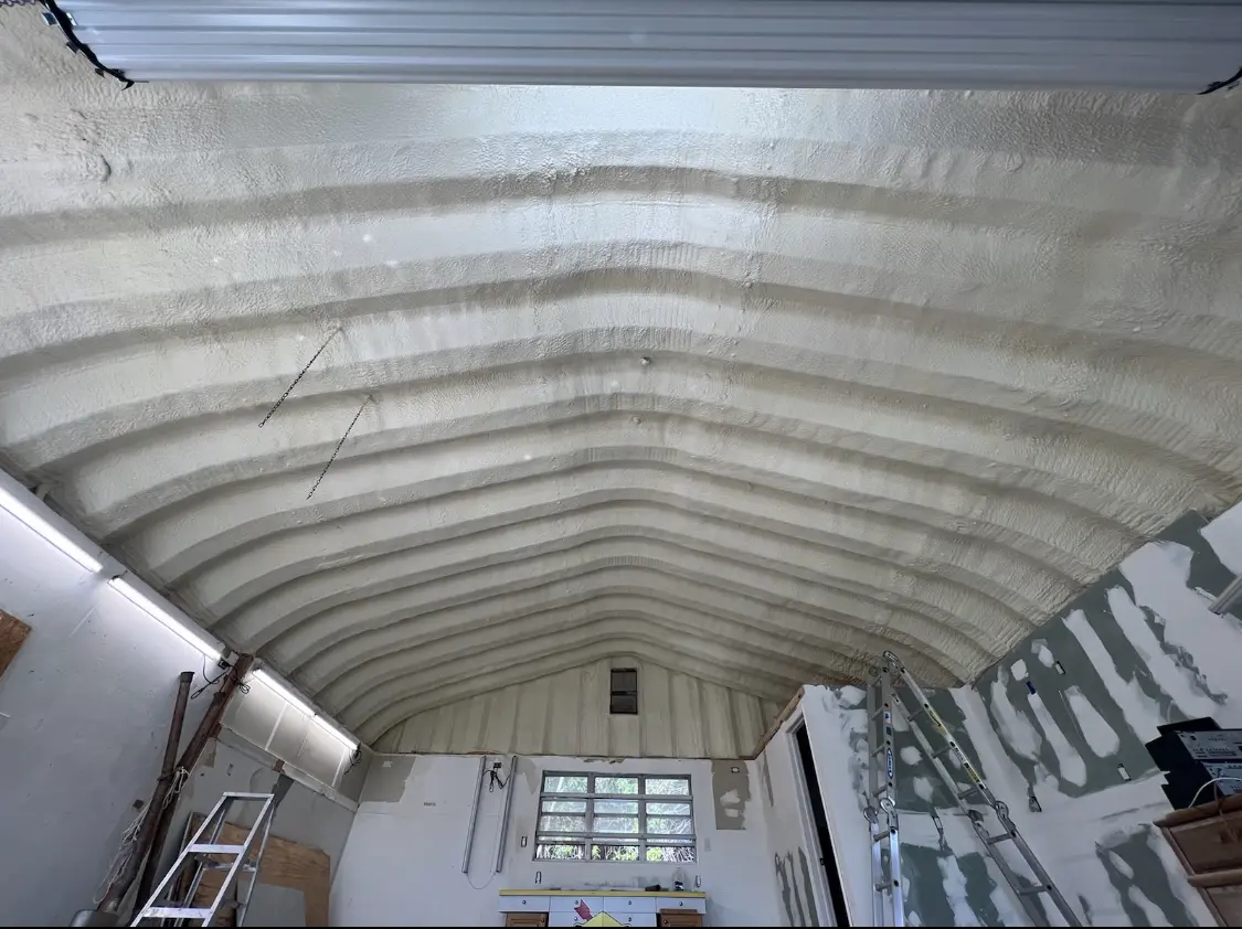 Spray polyurethane foam applied to the underside of a metal roof deck in Norwalk